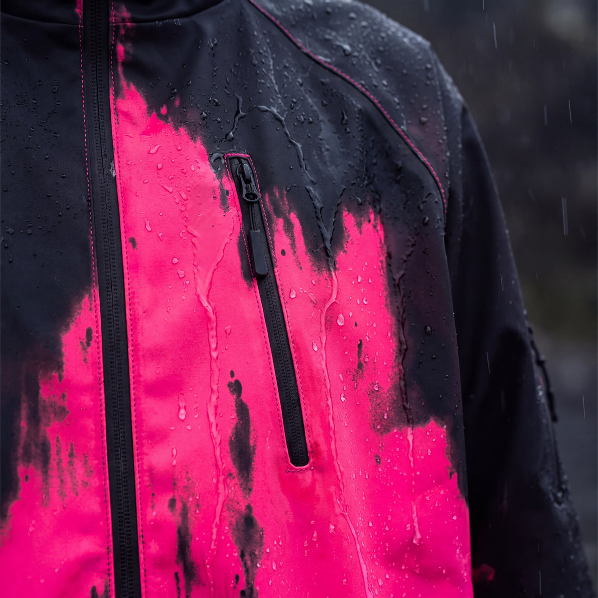 Close-up of the RainRunner jacket color edge where rain reveals the pink