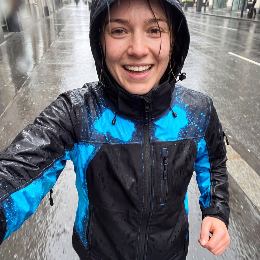 Runner taking a selfie in the Blue RainRunner jacket in the rain